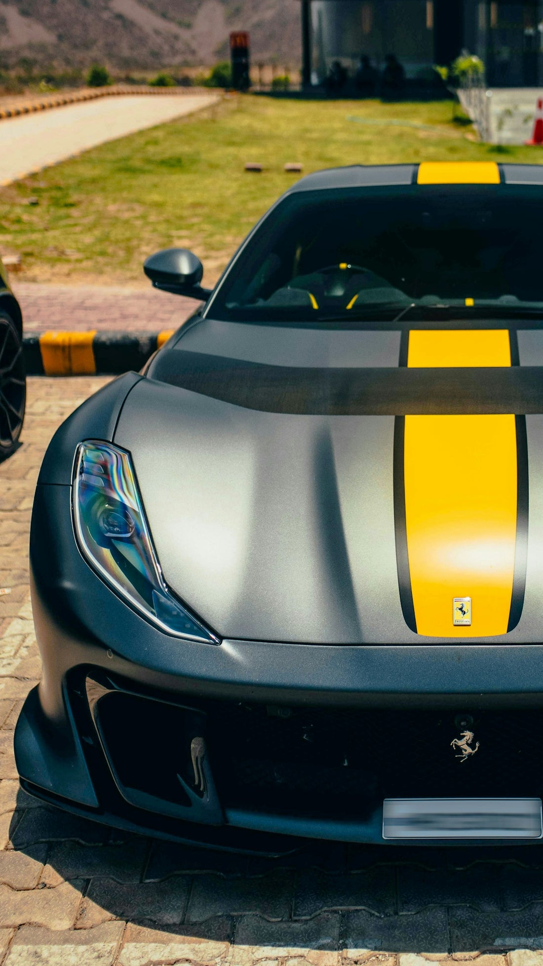 A black and yellow sports car parked in a driveway