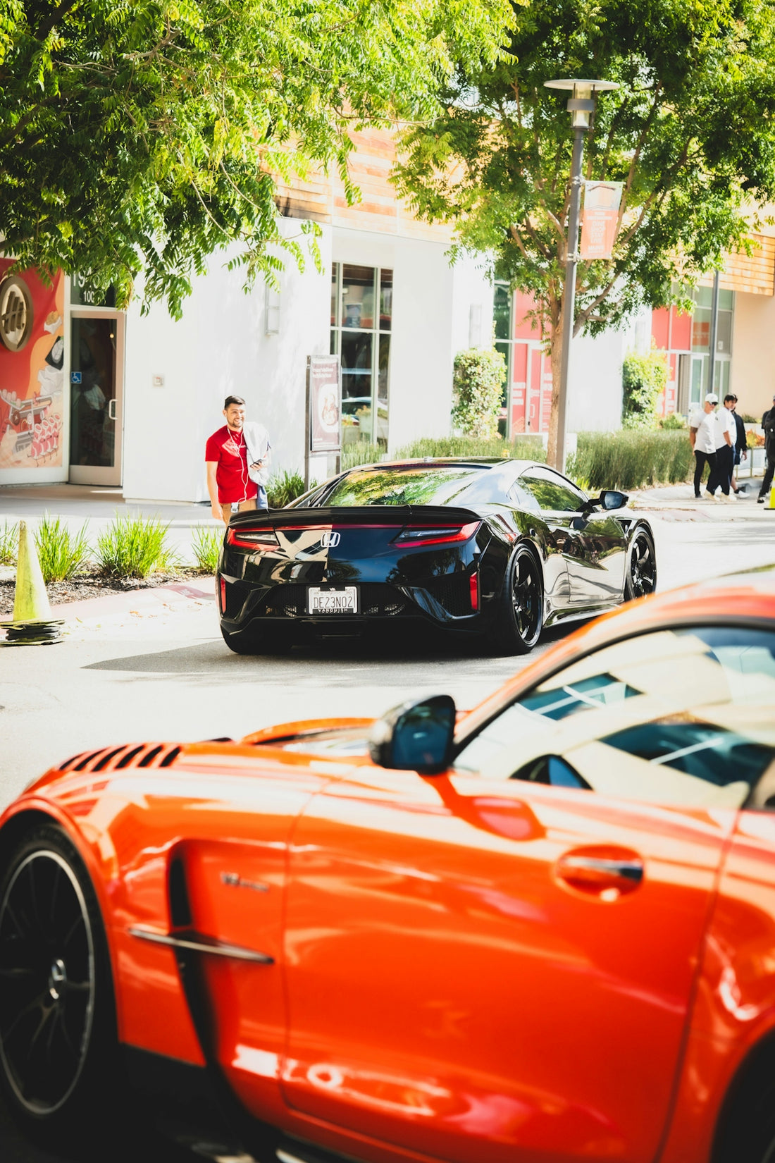 Two sports cars parked on a street