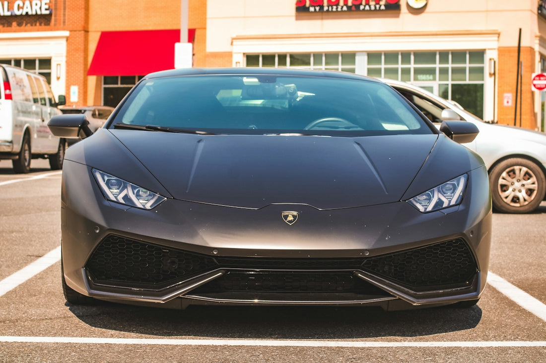 A dark sports car parked in a lot