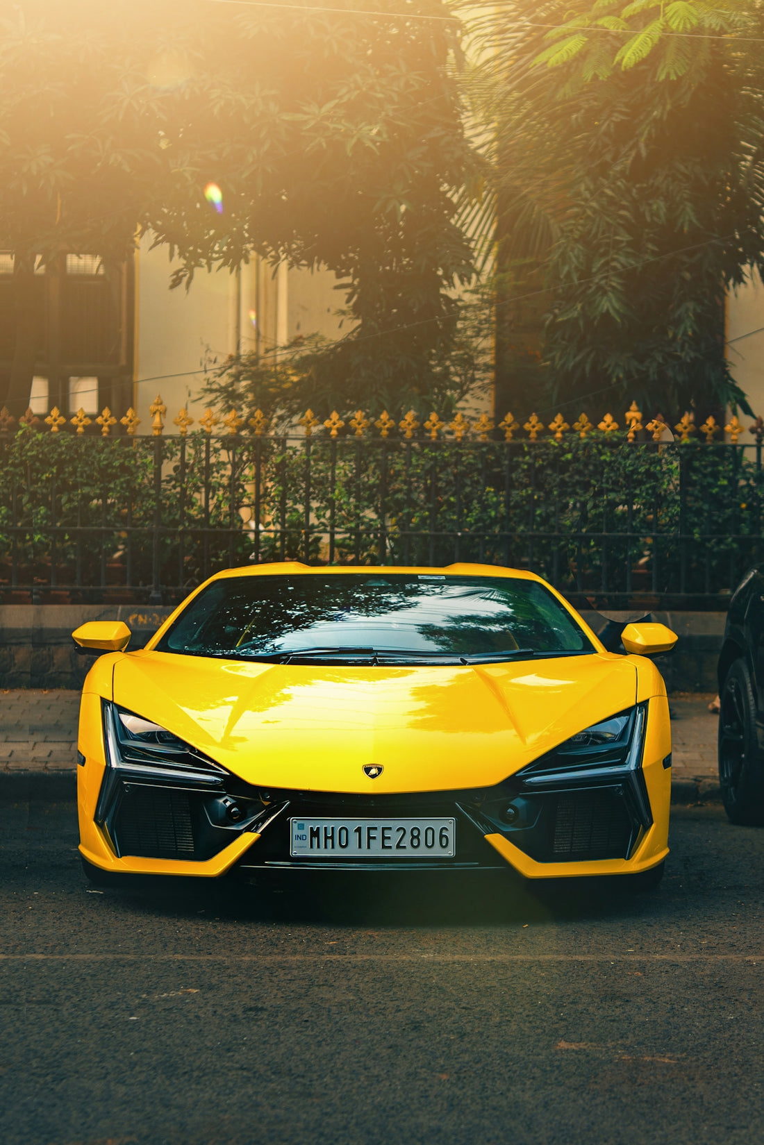 A bright yellow sports car parked on a street