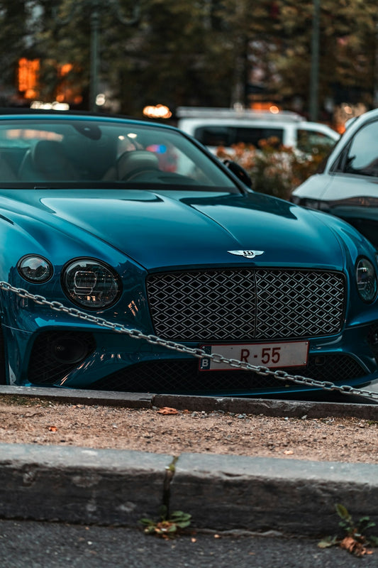 A sleek blue bentley car parked outdoors