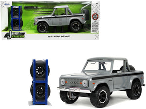 1973 Ford Bronco Pickup Truck Gray with Black Stripes with Extra Wheels "Just Trucks" Series 1/24 Diecast Model Car by Jada - Premium Pickup Trucks Models from Jada - Just $55.09! Shop now at Rapidvehicles